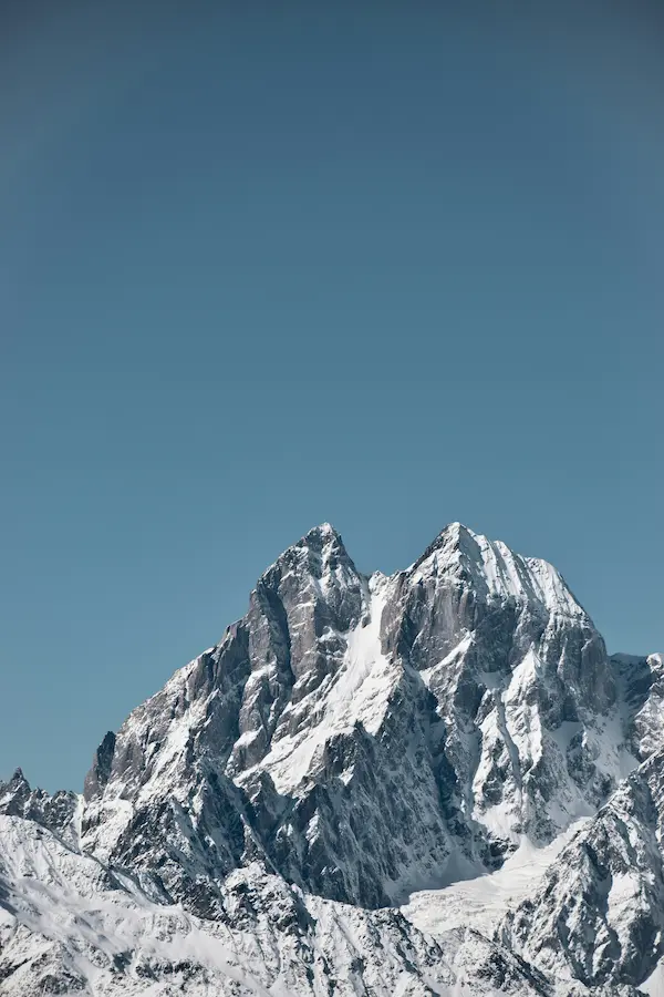 Closeup shot of top of Ushba mountain with clear blue sky in the background